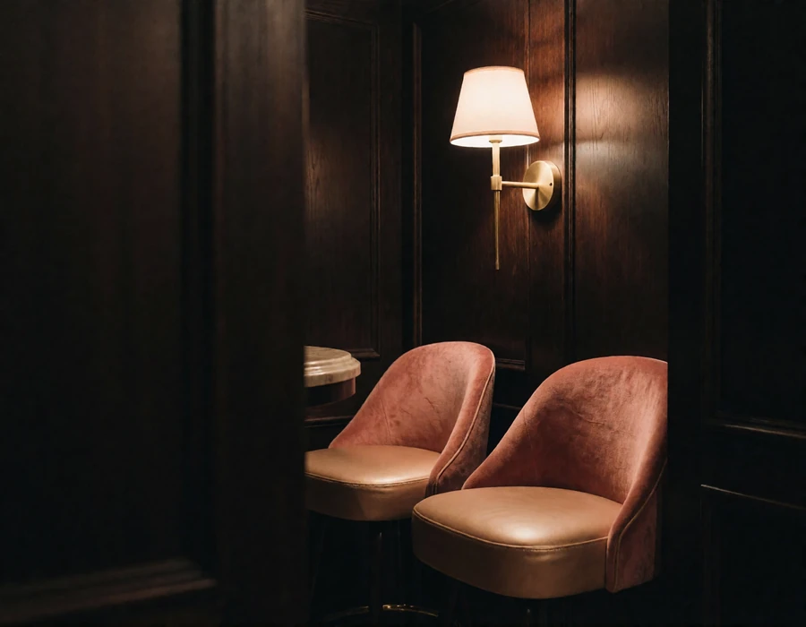 Narrow wood-panelled listening bar with velvet stools and a warm brass wall lamp on Capitol Hill