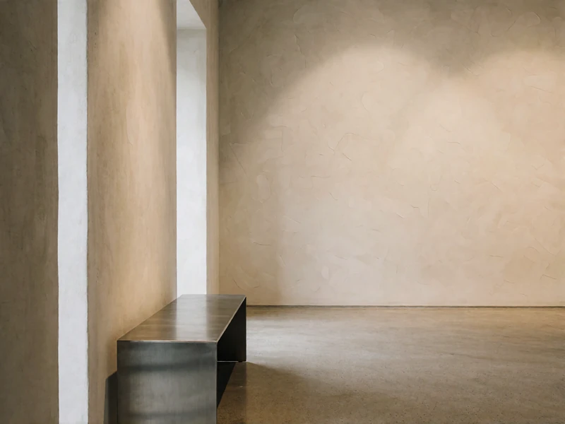 Quiet contemporary gallery interior with pale walls and soft directional lighting in the Dallas Arts District