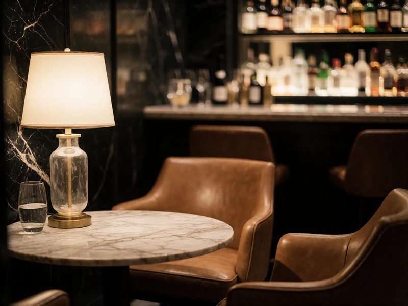 Quiet upscale hotel bar corner with low armchairs and warm lamplight, a suitable Houston first-meeting venue